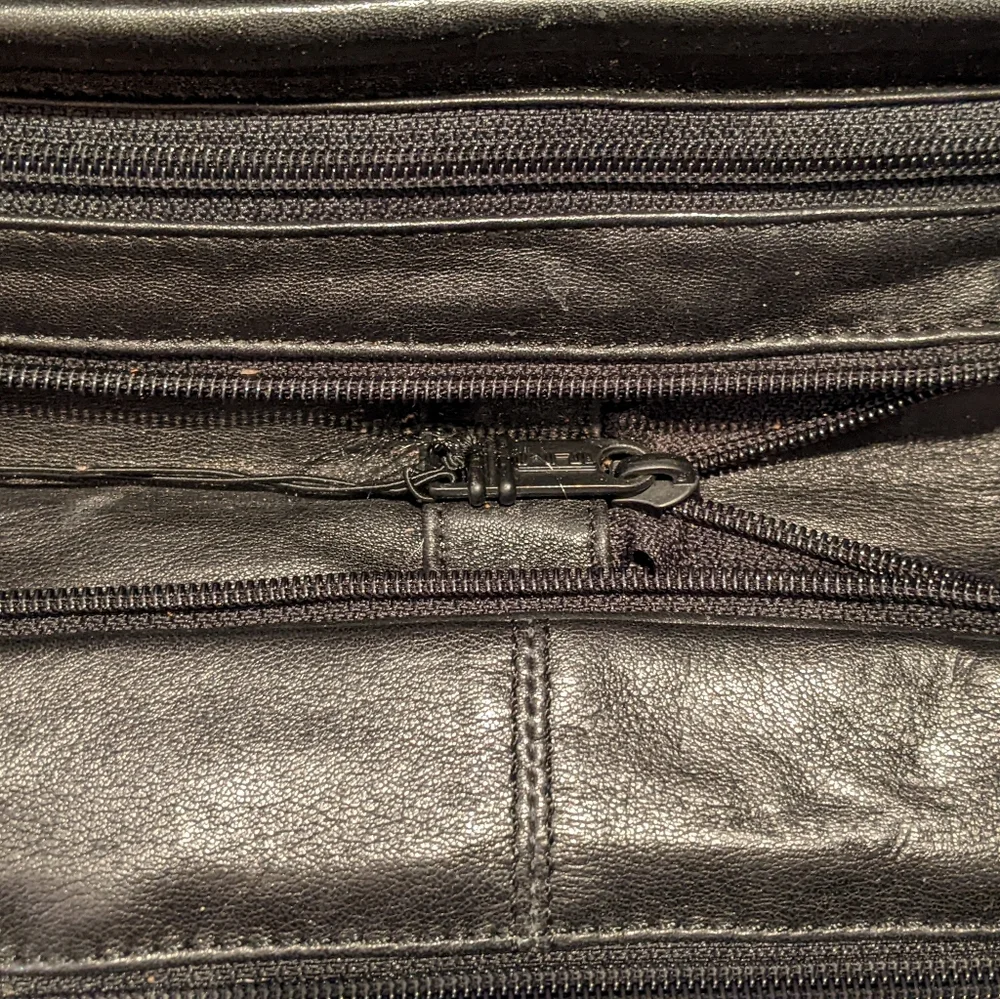 Black Tumi expandable briefcase. Fits 15